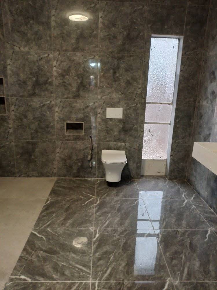 Marble-tiled bathroom with window