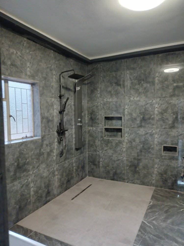 Walk-in shower with grey stone tiling