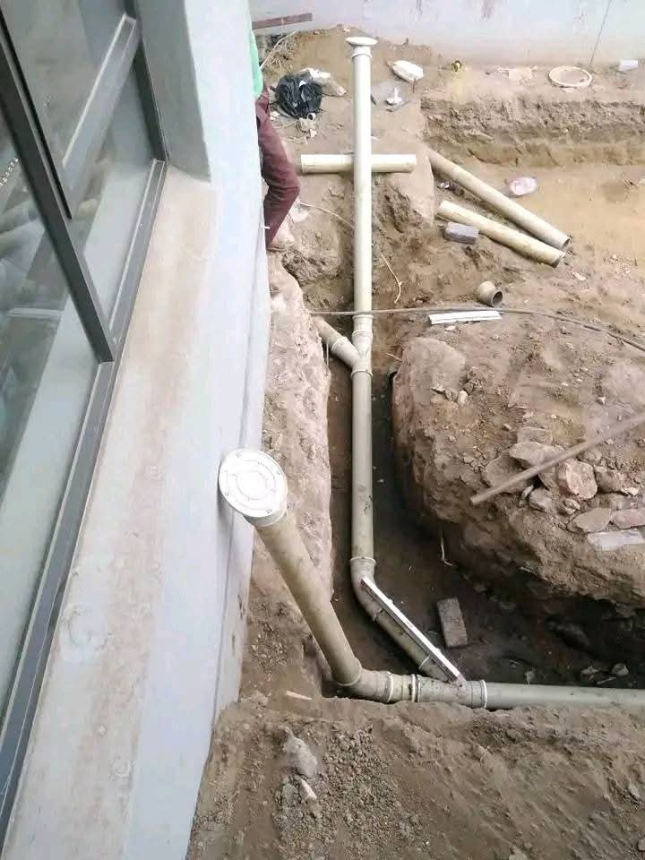 Drainage pipework in a trench outside a building