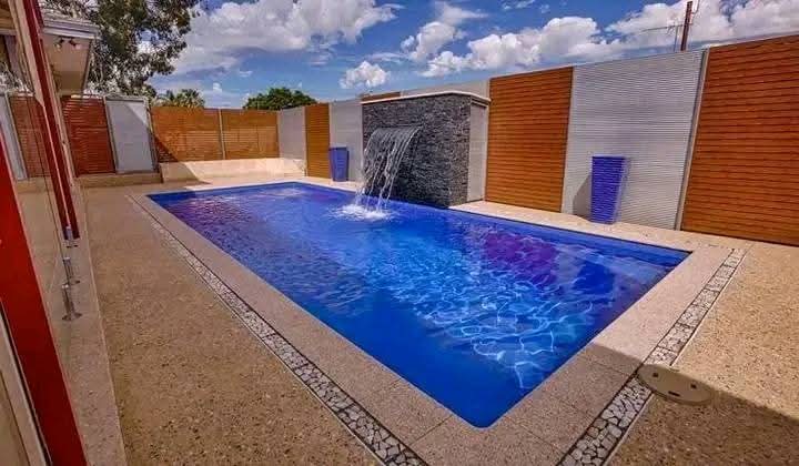 Newly built swimming pool with a stone feature wall