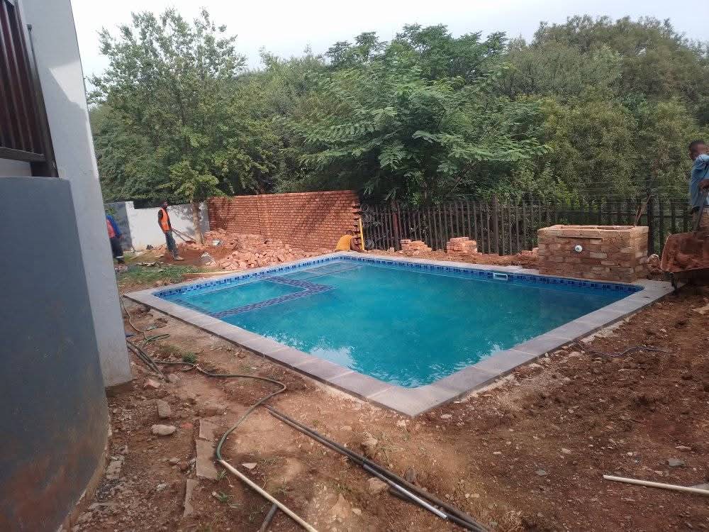 Pool shell built next to a house